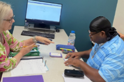 Person working on literacy with an adult