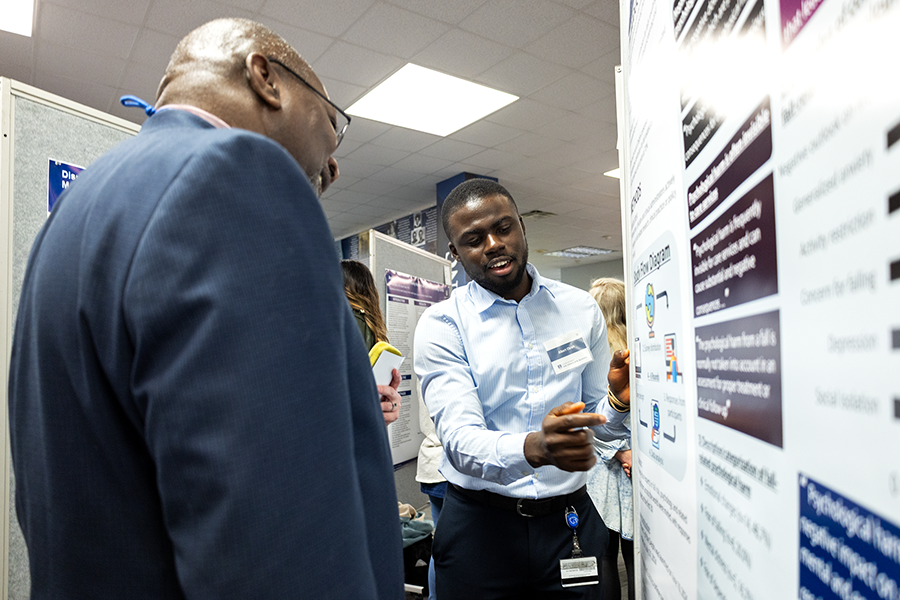 College student talking about research with faculty member
